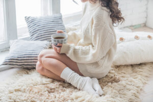 woman sitting in the white sweater